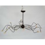 Mid Century : a patinated bronze finish ceiling light , a Spider Ceiling Lamp , having 15 arms,