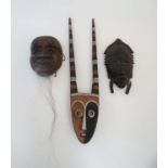 Ethnographic Native Tribal : two assorted African wall masks , one with banded horns ,