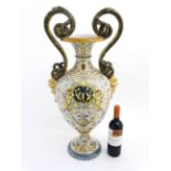 A large late 19thc Italian majolica two handled pedestal urn vase with flared rim,