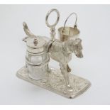 A 21stC novelty silver plate cruet stand formed as a dog carrying a bucket formed salt and glass