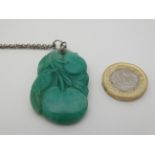 A carved green jade pendant depicting a bird with fruit 1 3/4" long CONDITION: