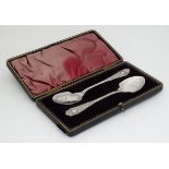A cased pair of silver plate preserve spoons with engraved decoration and spade formed bowls 8"