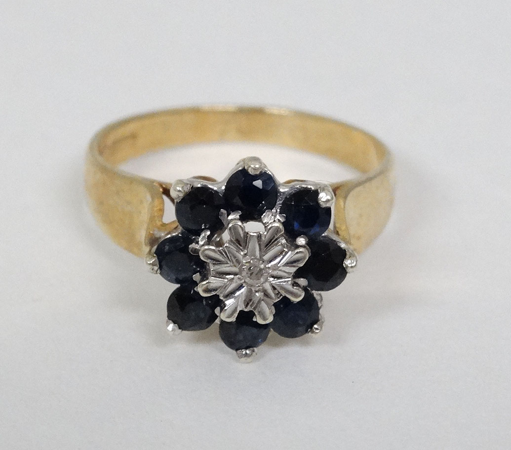 A 9ct gold ring set with central diamond bordered by blue stones CONDITION: Please