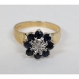 A 9ct gold ring set with central diamond bordered by blue stones CONDITION: Please