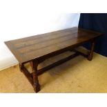 A 21stC oak peg jointed refectory table with a 4 plank top standing on four ring turned legs with