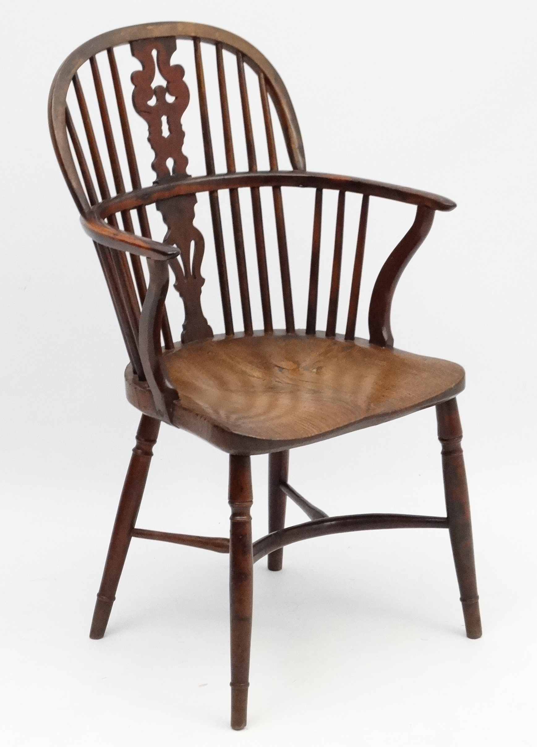 An 18thC Yew wood Windsor chair with elm seat shaped uprights and crinoline stretcher.