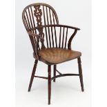 An 18thC Yew wood Windsor chair with elm seat shaped uprights and crinoline stretcher.
