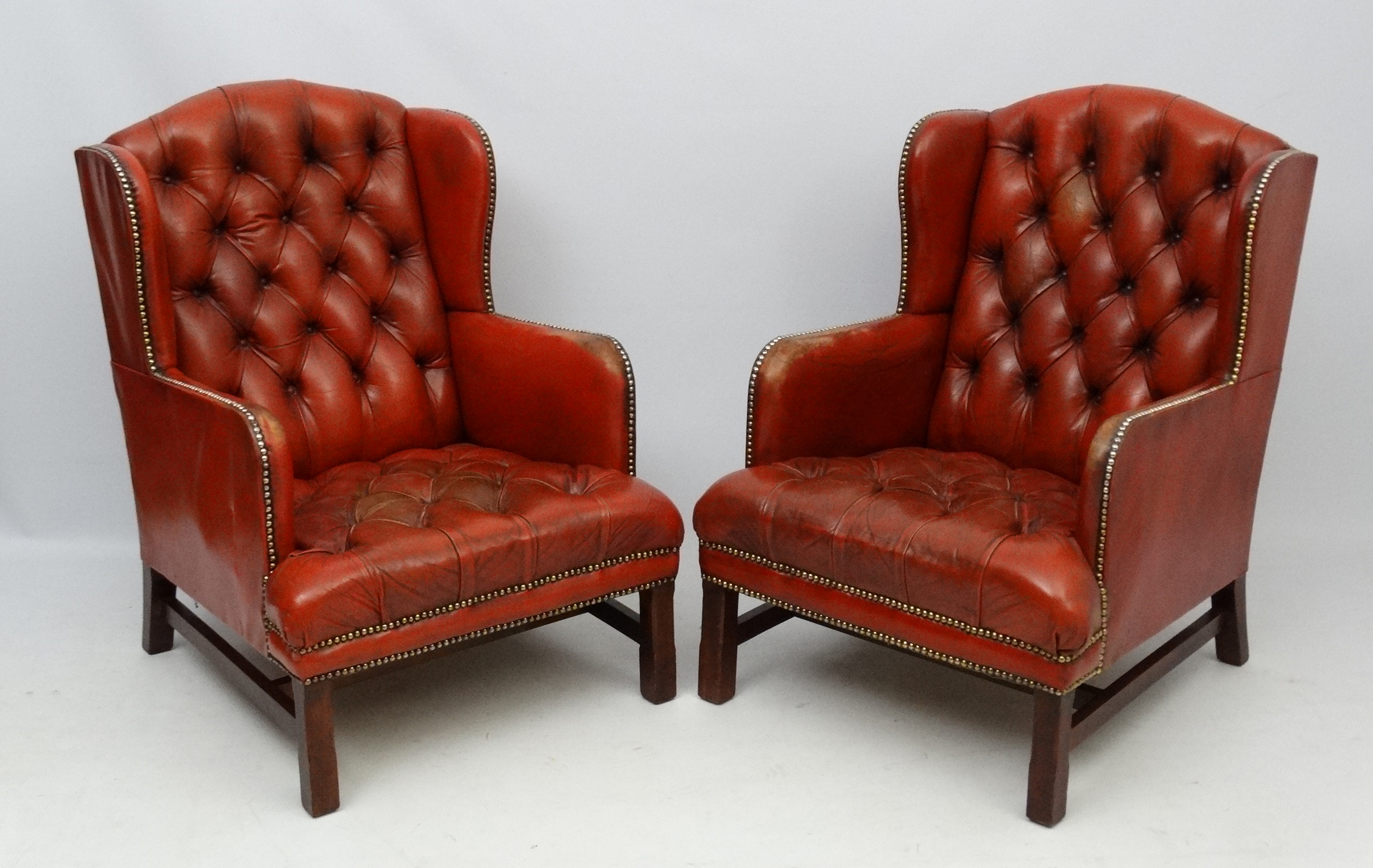 A pair of 20thC red leather wing back armchairs with button back and brass stud decoration 36 1/2" - Image 5 of 5