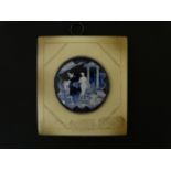 A 20thC enamel circular plaque on squared background depicting a classical scene within.