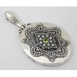 A white metal pendant locket set with central peridot 2" long CONDITION: Please