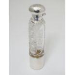 A cut glass ladies him flask of cylindrical form with silver top, mounts and beaker to lower.