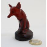 A small Royal Doulton Flambe figure of a seated fox, HN 147C, bears factory stamp to base.