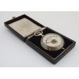 An unusual cased hand-held Voltmeter , housed within a pocketwatch case .