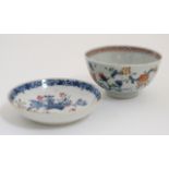 Two blue and white Chinese Export bowls each decorated with flowers with hand coloured details.