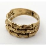 A 9ct gold ring set stylised banded bamboo decoration CONDITION: Please Note - we