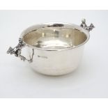 A silver bowl with two handles formed as a child with hobby horse.