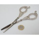 Silver handled grape scissors with cast loop handles decorated with fruiting vine and bow