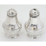 A silver salt and pepper cruet hallmarked Birmingham 1995/96 maker L J Millington.