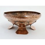 Decorative Metalware : A 19thC Arts and Crafts circular four footed bowl with hammered decoration
