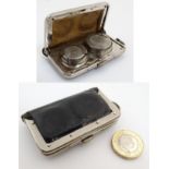 An early 20thC small purse opening to reveal a sprung loaded sovereign, half sovereign .