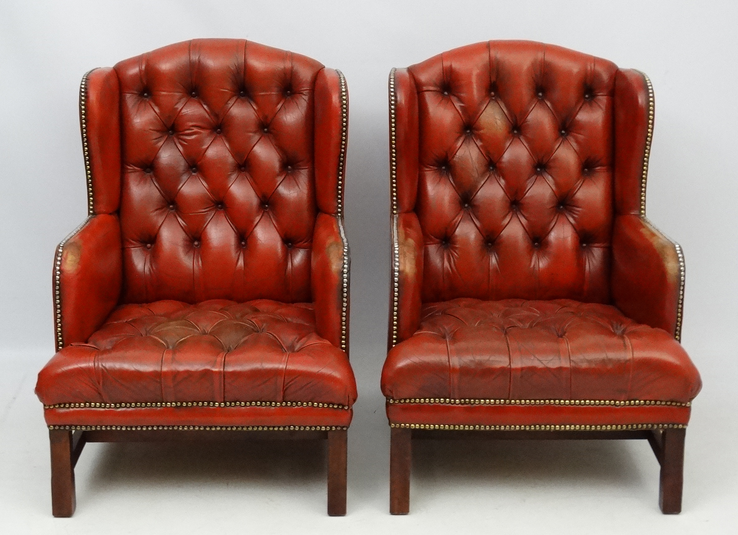 A pair of 20thC red leather wing back armchairs with button back and brass stud decoration 36 1/2" - Image 4 of 5
