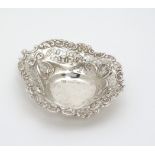 A Victorian silver bon bon dish of heart form with pierced and embossed decoration.