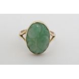 A 9ct gold ring set with carved jade like cabochon CONDITION: Please Note - we do