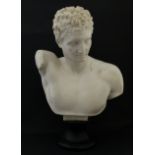 A composite marble sculpture of the classical figure Hermes on turned soccle base.