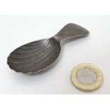 A Geo III silver caddy spoon with scallop shell formed bowl and bright cut decoration to handle