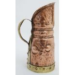 Decorative Metalware : An Arts and Crafts embossed copper and brass jug with copper rivets.