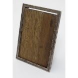 A silver photograph frame with easel / strut back, hallmarked Birmingham 1925 .