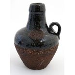 Scandinavian Pottery: A mid 20thC Gabriel , Sweden Studio Pottery loop handled bottle vase,