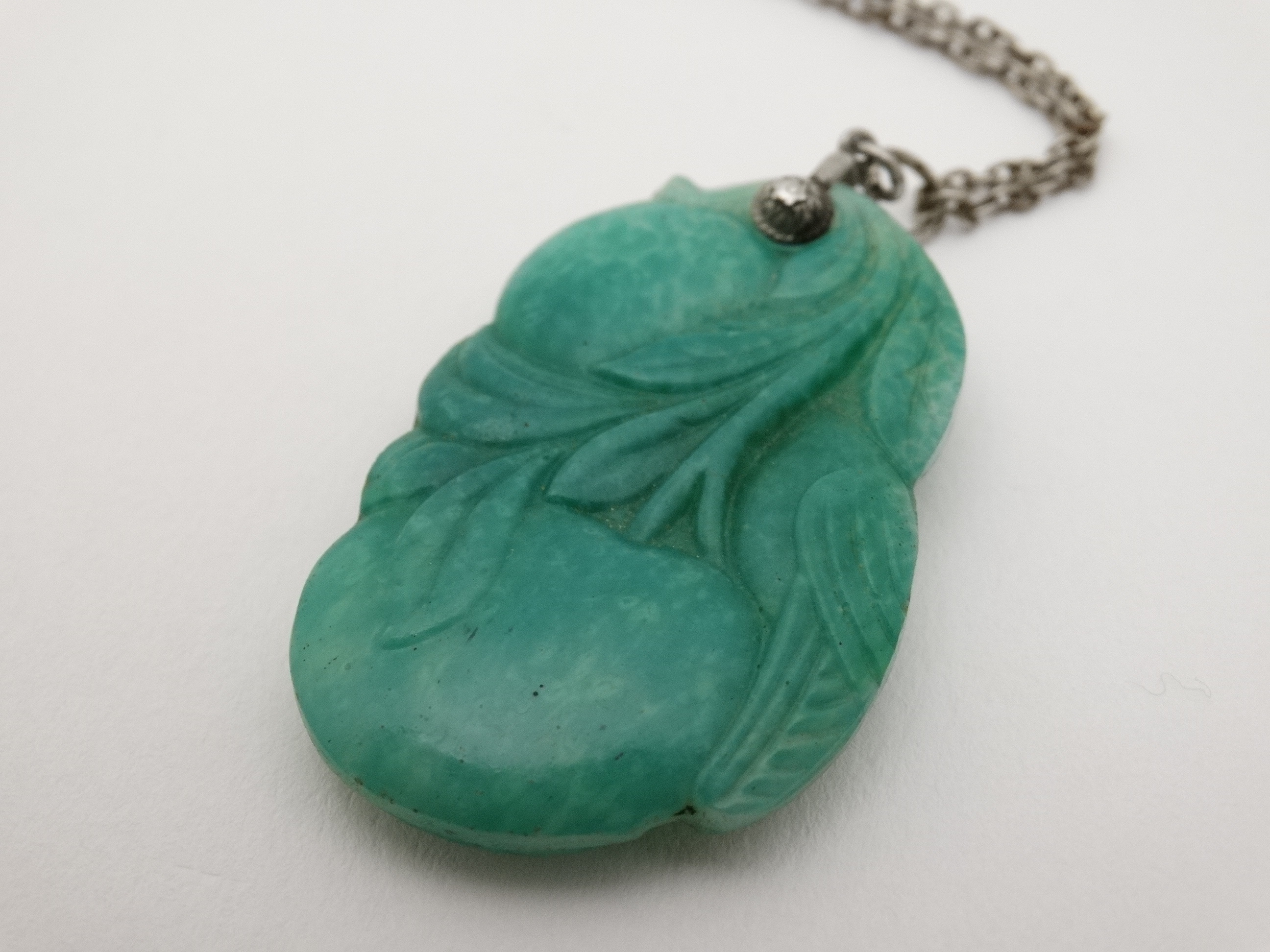 A carved green jade pendant depicting a bird with fruit 1 3/4" long CONDITION: - Image 2 of 4