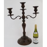 A Large marbled brown painted metal 2 branch candelabra on circular base 24" high