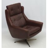 Vintage Retro: A Scandinavian leather swivel wingback armchair in brown leather ,