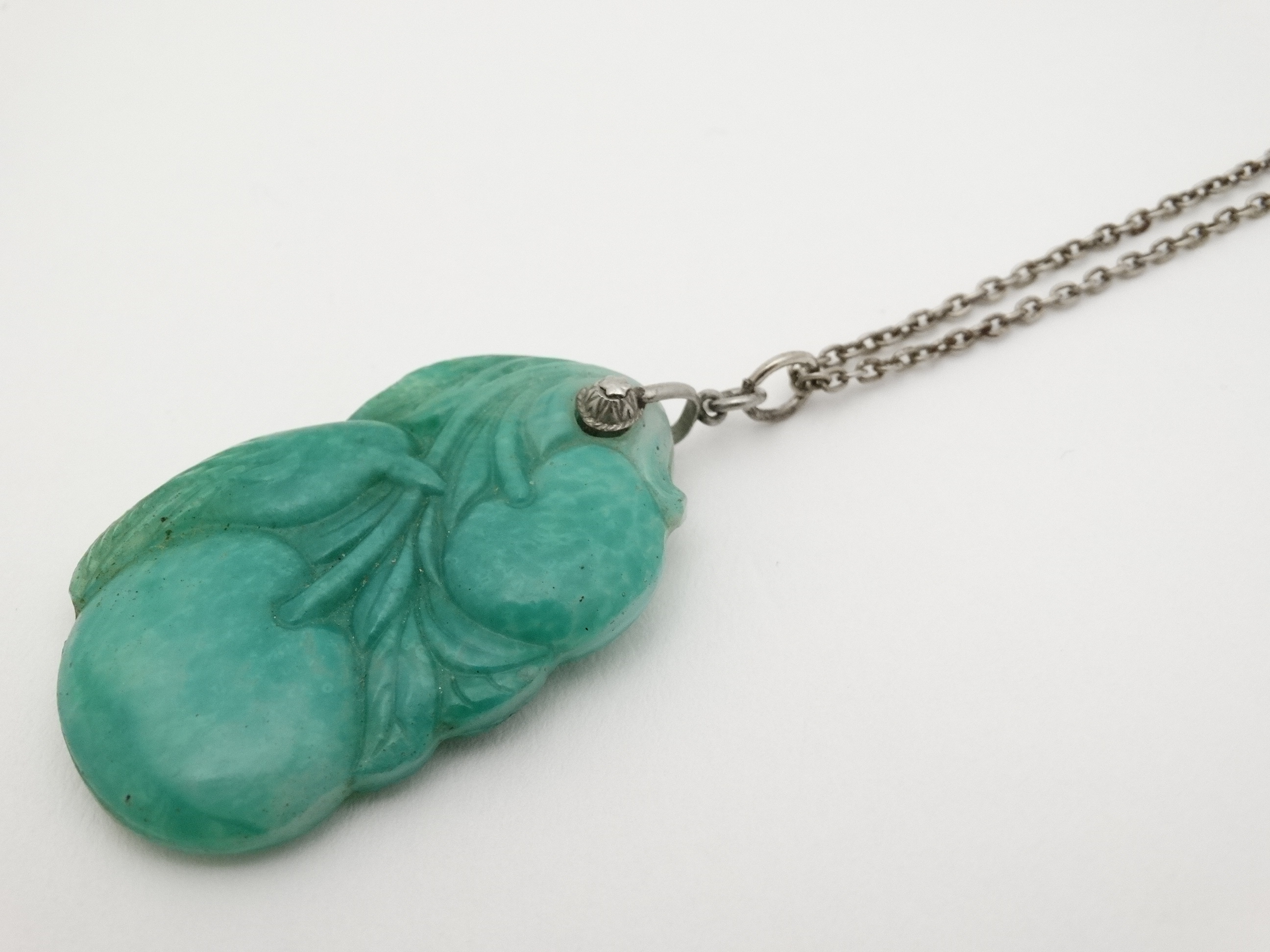 A carved green jade pendant depicting a bird with fruit 1 3/4" long CONDITION: - Image 4 of 4