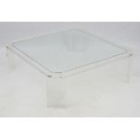 Mid Century : a large Lucite ? coffee table with four legs and canted corners ,