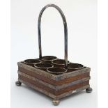 A silverplate and oak 6 division condiment / cruet stand, on bun shaped feet,