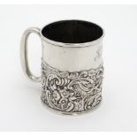 A silver Christening mug / tankard with acanthus, C-scroll, dolphin floral and mask decoration.