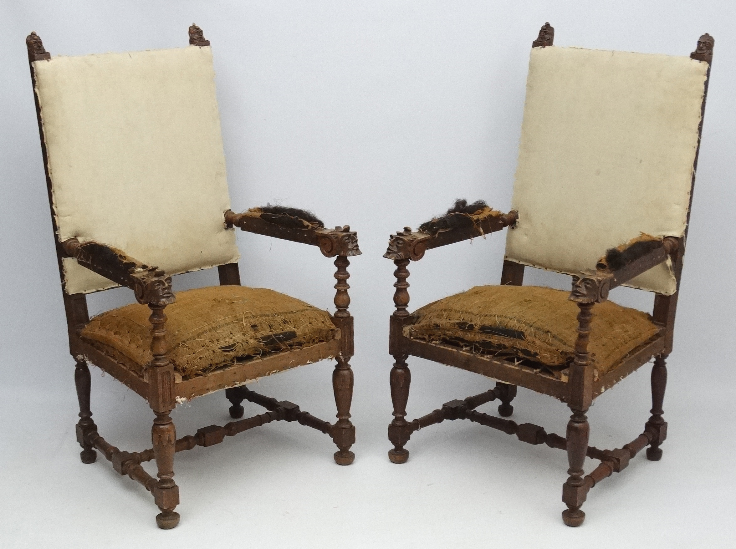 A pair of late 19thC Continental carved oak over sized open arm elbow chairs 49" high