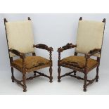 A pair of late 19thC Continental carved oak over sized open arm elbow chairs 49" high
