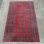 Carpet / rug : a hand Knotted Bokhara rug with 100 (4x 25) boteh like roundels to centre with red