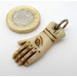 ' Give us a Hand ' An antler carved porters talisman pendant with carved eye decoration.