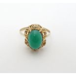 A 9ct gold ring set with green stone cabochon CONDITION: Please Note - we do not