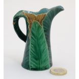 A small c1880 Worcester Majolica leaf jug in green and yellow with a turquoise interior,