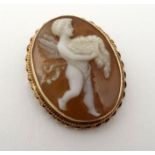 A carved cameo brooch / pendant depicting cherub within a yellow metal mount.