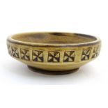 Scandinavian Pottery: A Scandinavian Studio Pottery bowl having brown decoration on a yellow ground.