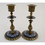 Decorative metalware : A pair of 19thC gilt brass and champleve enamel candlesticks,