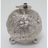 Chinese Export silver : A white metal table top lighter? of spherical form with dragon decoration.