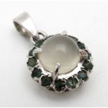 A silver pendant set with moonstone and sapphires 1" long CONDITION: Please Note -